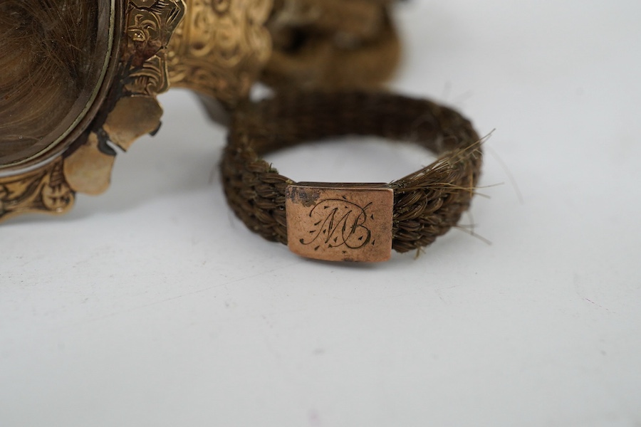 A Victorian yellow metal mounted plaited hair bracelet and two similar rings. Condition - poor